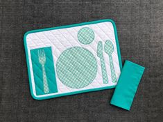 a close up of a place mat with utensils