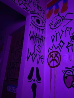 some graffiti on the side of a building with purple light in front of it and an evil eye painted on the wall