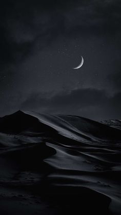 the moon is shining in the night sky over a desert landscape with sand dunes and hills