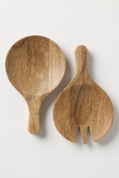 two wooden spoons sitting next to each other