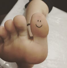 a person's foot with a smiley face drawn on it