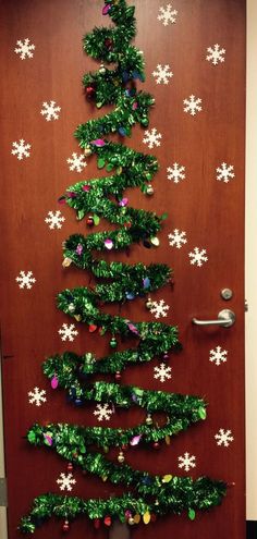 a door decorated with christmas trees and snowflakes