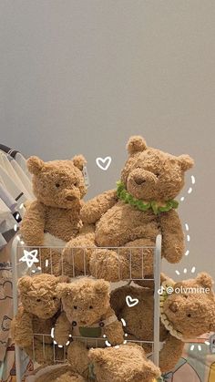 a bunch of teddy bears sitting in a wire basket