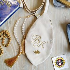 a white purse sitting on top of a table next to some beads and other items