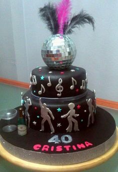 a birthday cake with disco balls and musical notes on it's top tiers