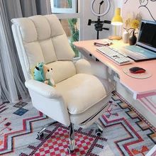 a white chair sitting in front of a desk with a laptop computer on top of it