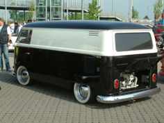 an old black and white van is parked