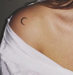 a woman with a crescent tattoo on her shoulder