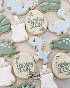 some cookies that are on top of a table with writing in the middle and other decorations around them