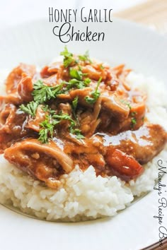 a white plate topped with rice and meat covered in sauce