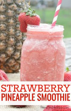 a strawberry pineapple smoothie in a mason jar with strawberries on the side