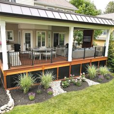 a house with a deck and patio in the front yard