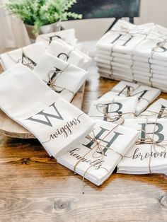 white napkins tied with twine on top of a wooden table