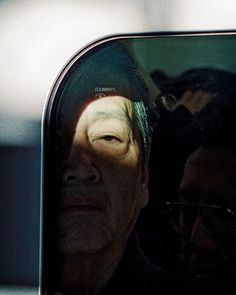 an older man is reflected in the side view mirror