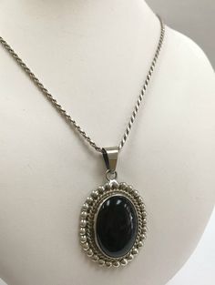 Welcome To Gold Knox Beautiful vintage Mexico sterling silver Taxco necklace with oval black onyx stone surrounded in beaded frame. Great gift for Christmas Details below: Material 925 Sterling Silver, onyx Weight 20.3 gm This would make great addition to your vintage silver collection. Thank you for looking Gold Knox opened its storefront in Pasadena, CA in 2011, since then we have an online store on eBay, and we joined Etsy in 2016 where we offer our unique and desirable items for you. Most al Silver Oval Onyx Necklace, Silver Onyx Oval Necklace, Classic Oval Onyx Necklaces, Classic Onyx Oval Cabochon Jewelry, Silver Onyx Oval Pendant Jewelry, Silver Onyx Oval Pendant, Classic Sterling Silver Necklace With Oval Cabochon, Vintage Black Oval Pendant Jewelry, Vintage Onyx Oval Cabochon Jewelry