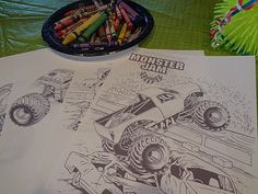 a table topped with paper and crayons next to a plate of crayons