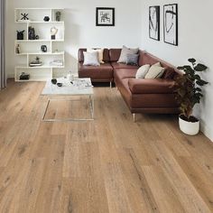 a living room with white walls and wood flooring on the floors is pictured in this image