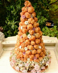 there is a cake made out of donuts on top of the table with flowers