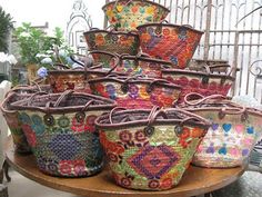 several baskets are stacked on top of each other in the middle of a wooden table