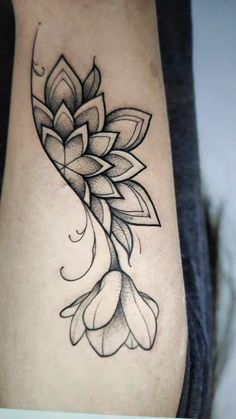 a woman's leg with a flower tattoo on it