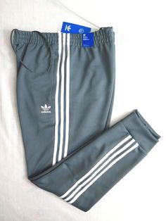 Fresh Stock Brand New with Tags ADIDAS ORIGINALS Men's SST Track Pants Size XL (X-Large) in Blue Oxide Color Waist Measurement Unstretched: 36" (91cm) Inseam: 31" (79cm) Outseam: 39" (99cm) Leg Opening: 6" (15cm) Front Rise: 11" (28cm) - Slim fit - - Elastic waist with drawcord - - Heavyweight fabric - - Machine wash - - Front zip pockets - - Ribbed cuffs - - Tapered legs - - Adidas Originals Trefoil logo at left thigh - From Smoke Free Environment in Stock! Ship Immediately from California! Pic Adidas Originals Mens, Pants Blue, Waist Measurement, Tapered Legs, Track Pants, Adidas Originals, Zip Pockets, Elastic Waist, Sweatpants