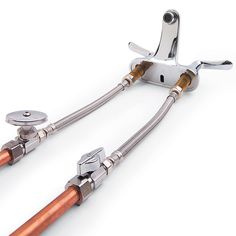 two metal levers with copper colored handles on each end and an orange handle on the other side