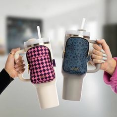 two people holding cups with the same pattern on them