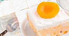 there is a piece of cake with an orange on top