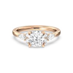 a yellow gold engagement ring with three stones