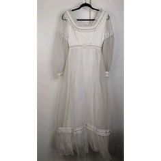 This Vintage 80s Dress Is A Beautiful Addition To Any Wardrobe. With A Bohemian Look And A Maxi Style, It's Perfect For A Wedding Or Any Special Occasion. The Ivory Color And Ribbon Detailing Add A Touch Of Elegance To The Dress. The Dress Is Made In The United States And Is An Original Piece From The 1980s. It's A Size 8 And Fits Regular Size Types. The Dress Is Perfect For Anyone Who Loves Vintage Clothing And Wants To Add A Touch Of History To Their Wardrobe. Good Preowned Condition Needs To Be Cleaned. Approx Measurements Are In The Photos White Vintage Long Sleeve Dress With Lace Trim, White Vintage Long-sleeve Dress With Lace Trim, White Retro Formal Dress, Vintage White Long Sleeve Dress, White Classic Vintage Dress For Formal Occasions, White Vintage Classic Formal Dress, White Lace Trim Vintage Dress For Events, White Vintage Dress For Formal Occasions, White Long Sleeve Vintage Dress