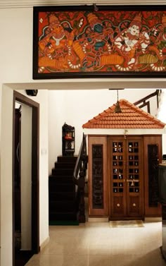 an entry way to a house with paintings on the wall