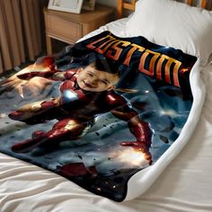 a bed with an iron man blanket on it