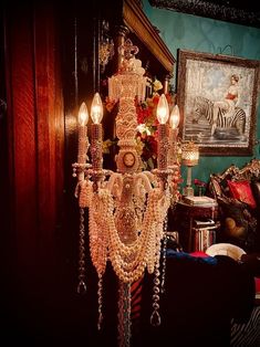 a fancy chandelier hanging from the side of a wall in a living room