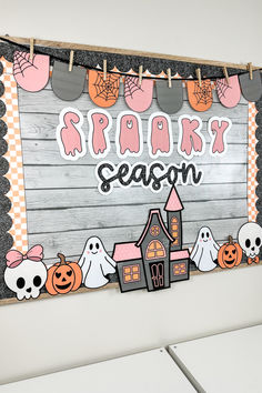 a wooden sign that says spooky season with ghost and pumpkins on it