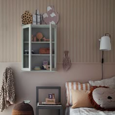 a small child's bedroom with striped wallpaper