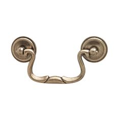 an antique brass metal hook on a white background