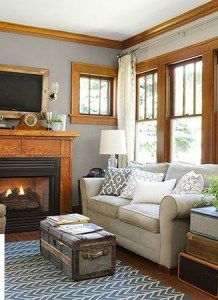 a living room filled with furniture and a fire place in front of a tv mounted on a wall