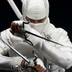 a man dressed in white holding two swords and aiming it at the viewer with both hands