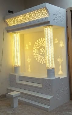 a white shrine with candles lit up in it