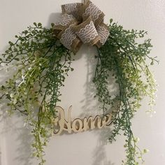 a wreath with the word home hanging on it