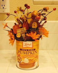 a can filled with lots of autumn decorations