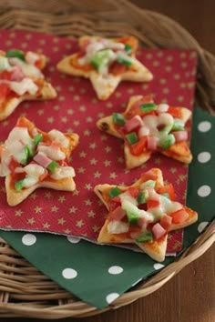 small appetizers are arranged on a red and green napkin