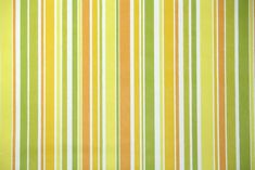 an orange and green striped wallpaper with vertical stripes