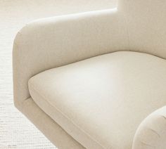 a white chair sitting on top of a carpeted floor