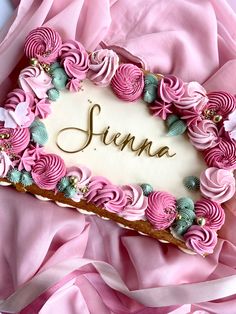 there is a cake that has been decorated with flowers and the name jenny on it