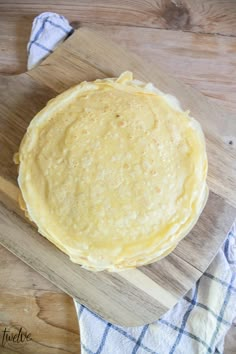 an uncooked pie sitting on top of a wooden cutting board