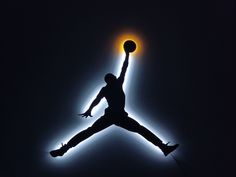 a basketball player jumping up in the air with his arms out to catch a ball