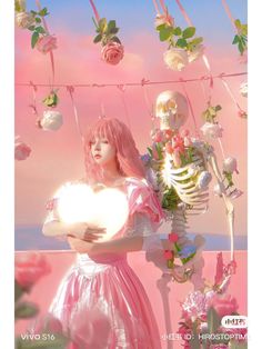 a woman with pink hair holding a white heart in front of a skeleton and flowers