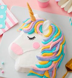 a cake decorated like a unicorn on top of a table