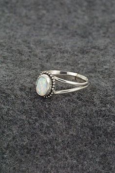 This opalite and sterling silver ring was made by Navajo silversmith Jan Mariano. The back is stamped sterling.Size: 8.5Length: 3/8"Width: 5/16"Free shipping on all orders! We ship with USPS and always include tracking. All orders ship within a day of payment.Returns are accepted up to 30 days after you receive your order. Just send us a message. Our shop offers cash back or store credit. The item must be returned in new condition. Bear Carving, White Buffalo, Pearl Chain, Native American Jewelry, Sterling Silver Ring, White Vintage, Sterling Silver Rings, Silver Ring, Jewelry Gifts